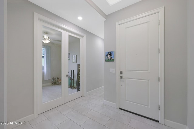 foyer with light tile patterned floors and french doors