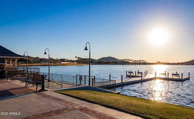 view of dock with a water and mountain view