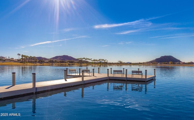 view of dock with a water and mountain view