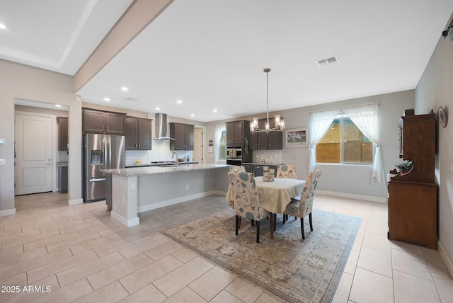 dining room featuring sink and an inviting chandelier