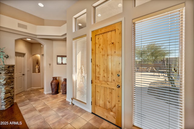 tiled entryway with a high ceiling