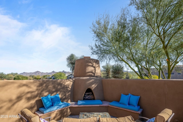 view of patio with a mountain view and an outdoor living space