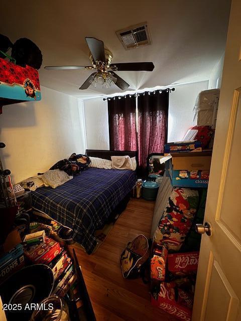 bedroom with ceiling fan and hardwood / wood-style flooring