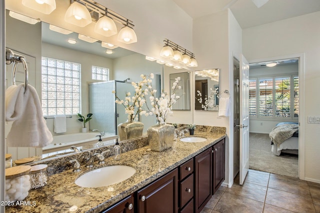 bathroom with independent shower and bath, vanity, and tile patterned flooring