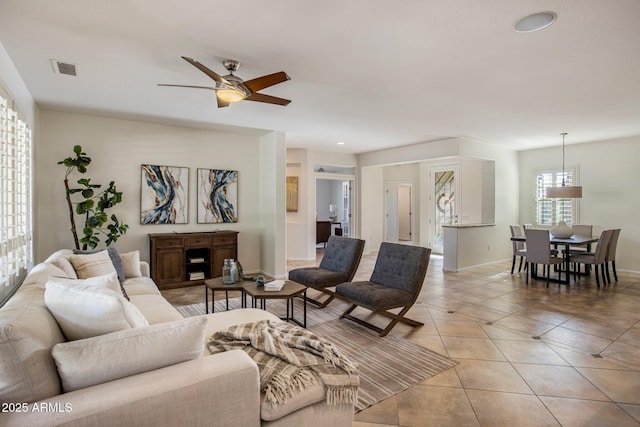 tiled living room with ceiling fan