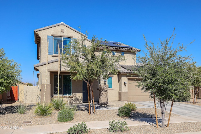 view of front of property featuring a garage and solar panels