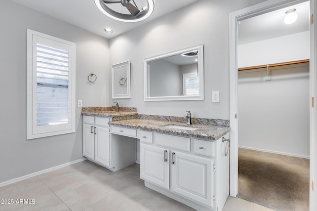 11217 E Laurel Ln, Scottsdale, AZ 85259 - full bath with double vanity, a walk in closet, and tile patterned floors