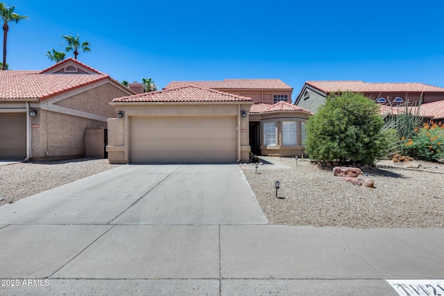 11217 E Laurel Ln, Scottsdale, AZ 85259 - mediterranean / spanish house with stucco siding, a garage, driveway, and a tile roof