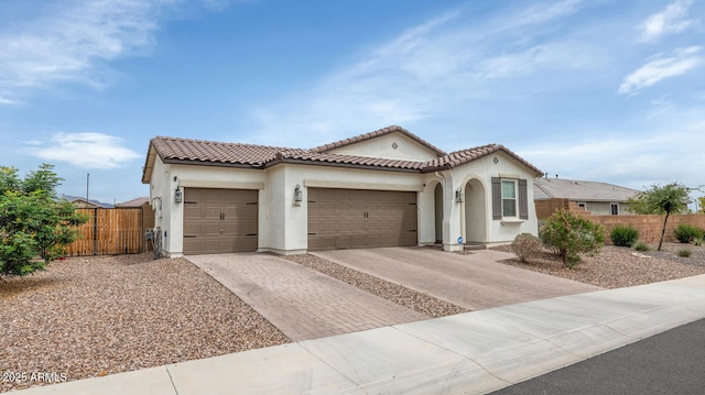 19806 W Marshall Ave, Litchfield Park, AZ 85340 - mediterranean / spanish-style house with an attached garage, stucco siding, driveway, and fence