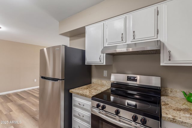 kitchen featuring light wood-style flooring, appliances with stainless steel finishes, white cabinetry, under cabinet range hood, and baseboards