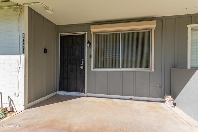 entrance to property featuring concrete block siding