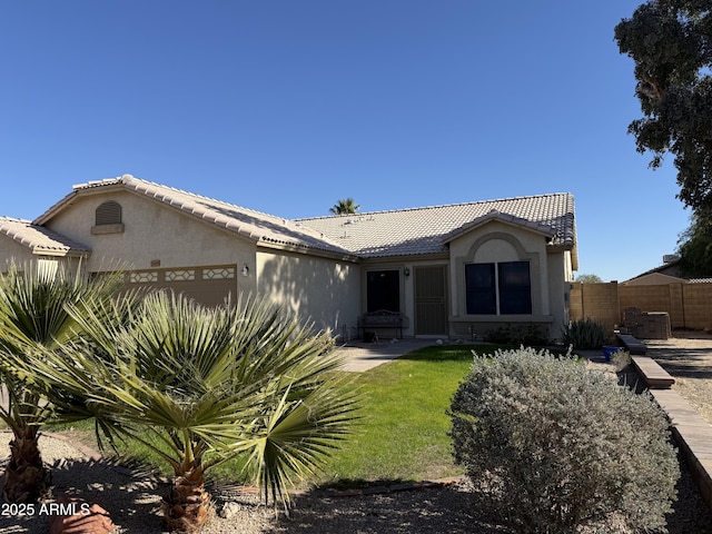 view of front of home featuring a front lawn and a garage