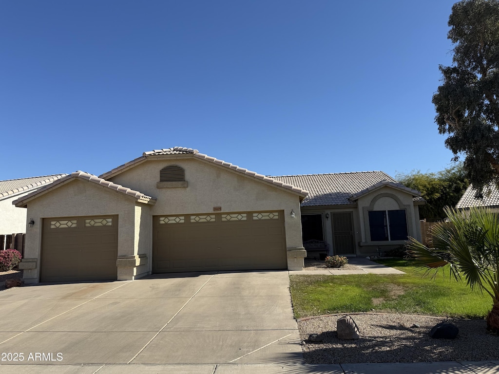 mediterranean / spanish-style house with a garage