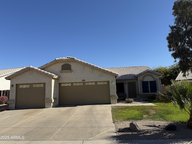 mediterranean / spanish-style house with a garage