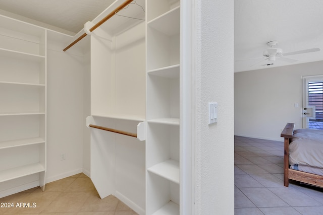 spacious closet featuring ceiling fan and light tile patterned floors