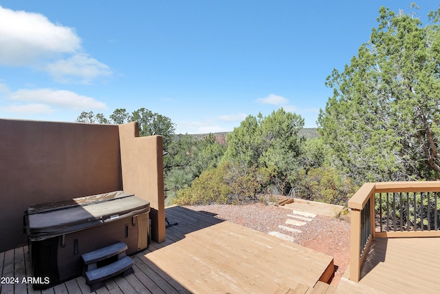 wooden terrace with a hot tub