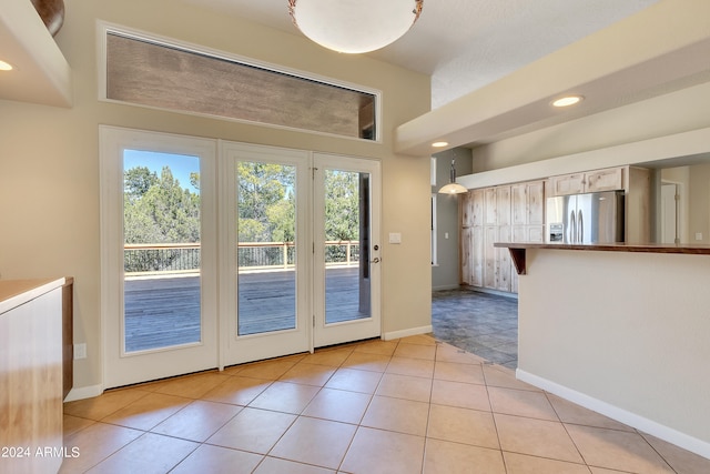 entryway featuring a textured ceiling and light tile patterned floors