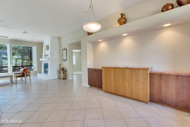 interior space with light tile patterned flooring and decorative light fixtures