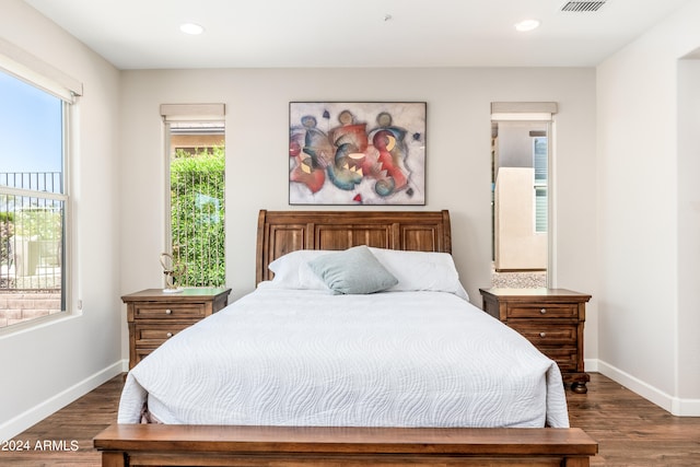 bedroom with dark hardwood / wood-style flooring