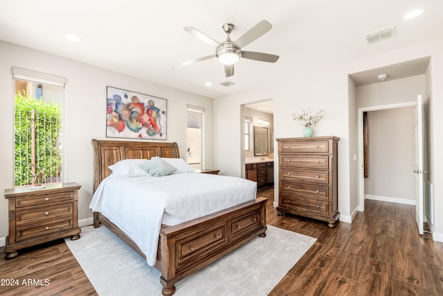 bedroom featuring ensuite bathroom, dark hardwood / wood-style flooring, and ceiling fan