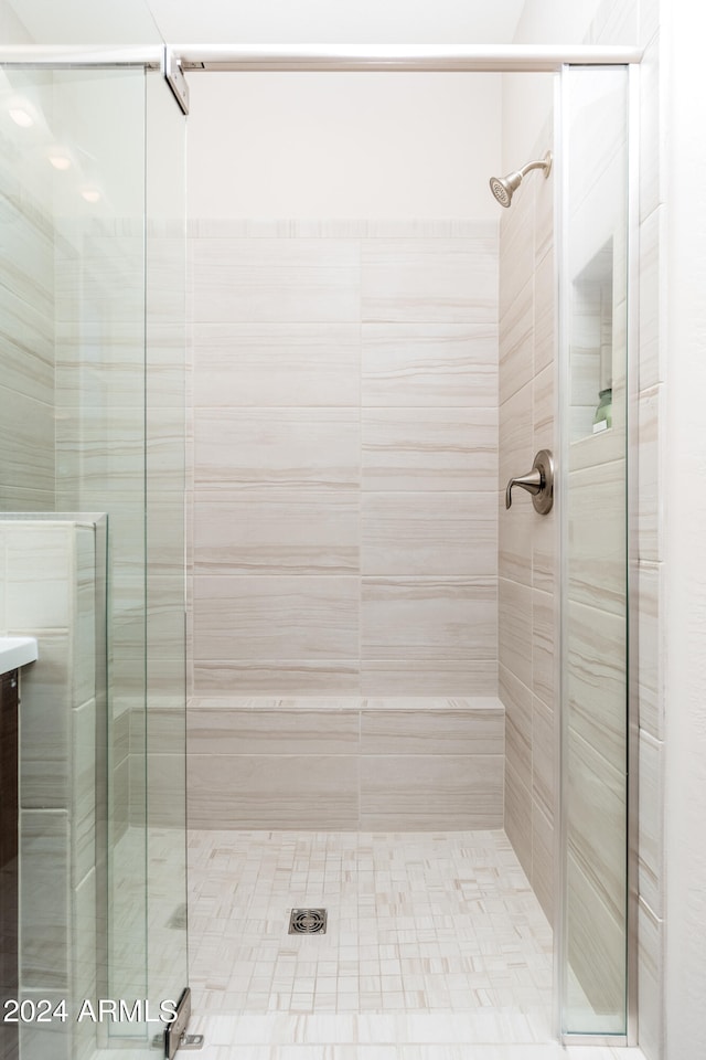 bathroom with walk in shower and vanity