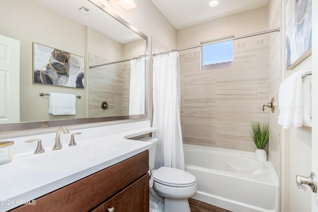 full bathroom featuring shower / bath combination with curtain, vanity, and toilet