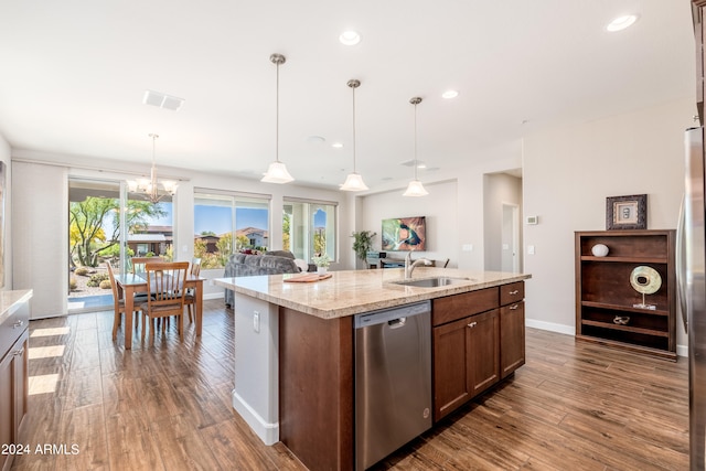 kitchen with pendant lighting, sink, dishwasher, dark hardwood / wood-style floors, and an island with sink