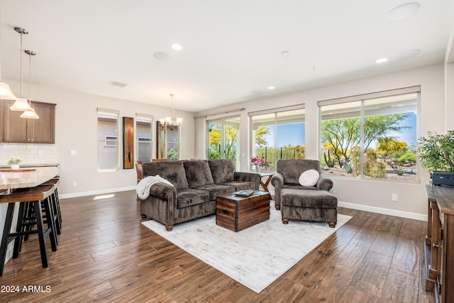 living room featuring a chandelier and dark hardwood / wood-style flooring