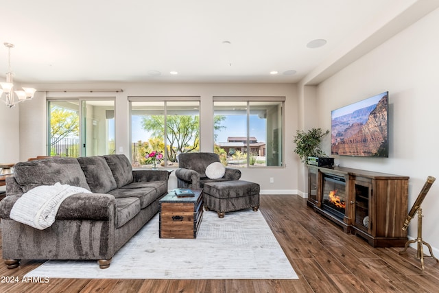 living room with hardwood / wood-style floors and a chandelier