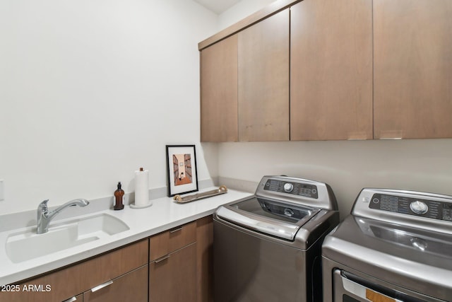 washroom with washer and dryer, sink, and cabinets