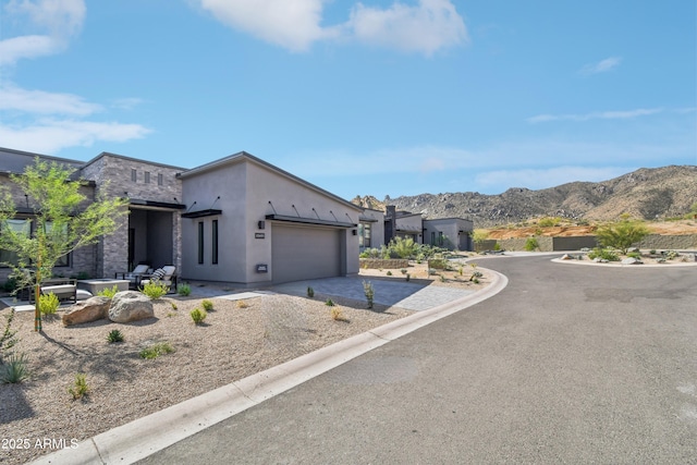 view of front of house featuring a garage and a mountain view