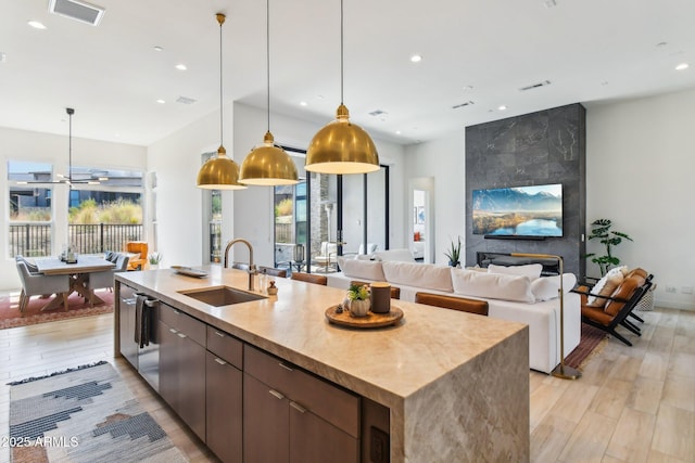 kitchen featuring sink, pendant lighting, and light wood-type flooring