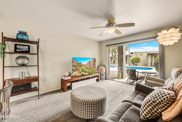 carpeted living room featuring a textured ceiling, ceiling fan, and baseboards