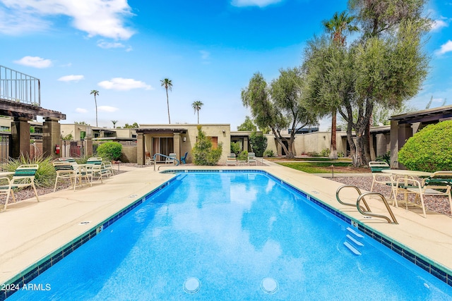 pool featuring a patio and fence