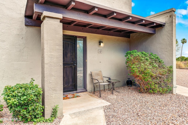 view of exterior entry with stucco siding