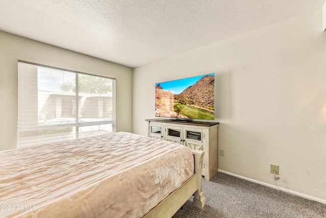 carpeted bedroom featuring baseboards, a textured ceiling, and a textured wall