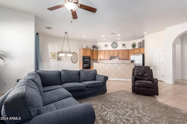 tiled living room with ceiling fan