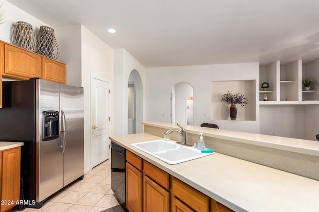 kitchen featuring light tile patterned flooring, stainless steel refrigerator with ice dispenser, black dishwasher, and sink