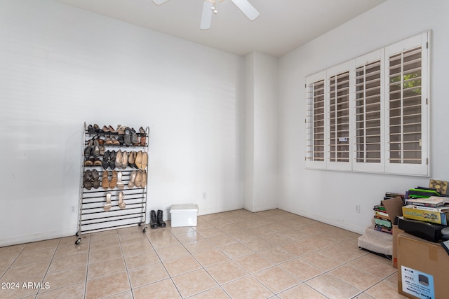 unfurnished room featuring ceiling fan and light tile patterned floors