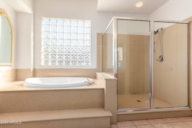 bathroom featuring tile patterned flooring and shower with separate bathtub