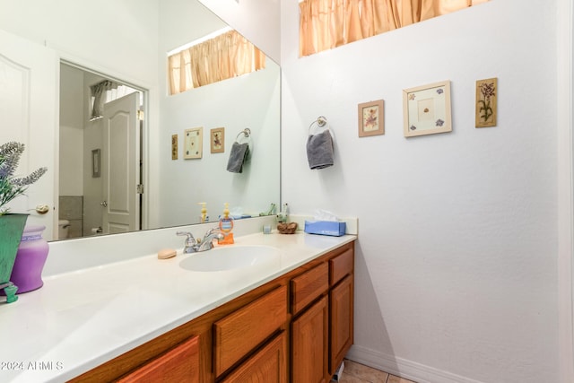 bathroom featuring tile patterned flooring, vanity, and toilet