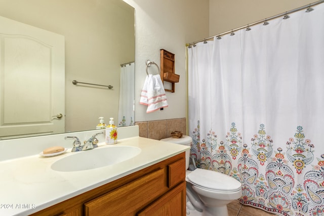 bathroom featuring tile patterned flooring, vanity, and toilet