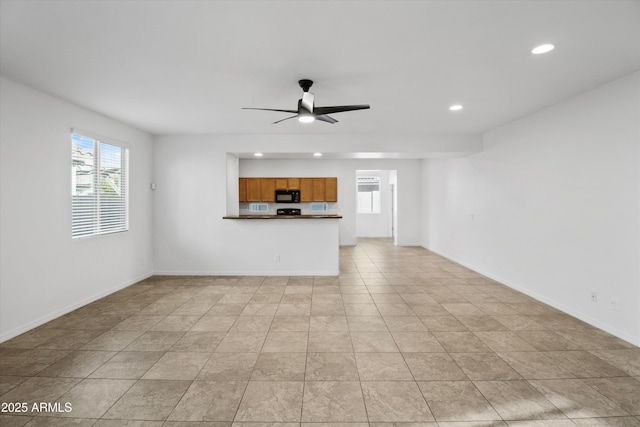 unfurnished living room with ceiling fan