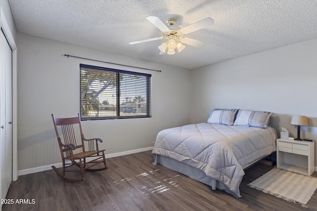 bedroom with ceiling fan, a closet, and dark wood-type flooring