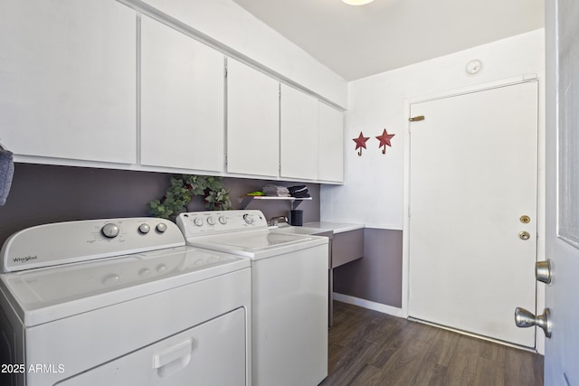 clothes washing area featuring cabinets, dark hardwood / wood-style flooring, sink, and washing machine and dryer