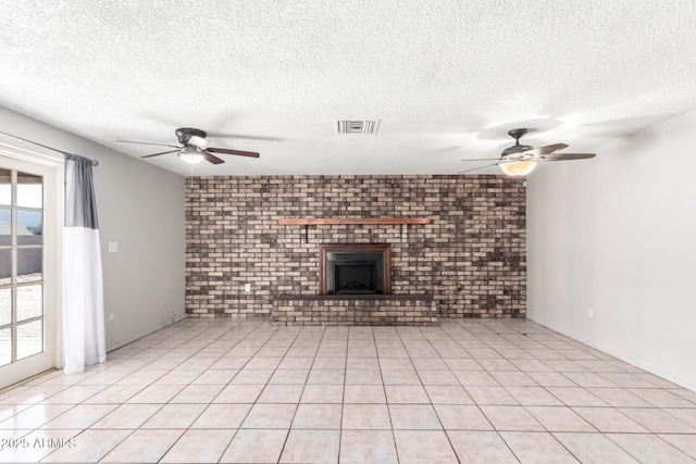 unfurnished living room featuring ceiling fan, a textured ceiling, light tile patterned floors, and a fireplace