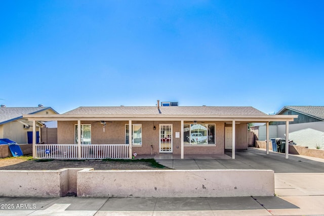 ranch-style house featuring ceiling fan, a carport, and a porch