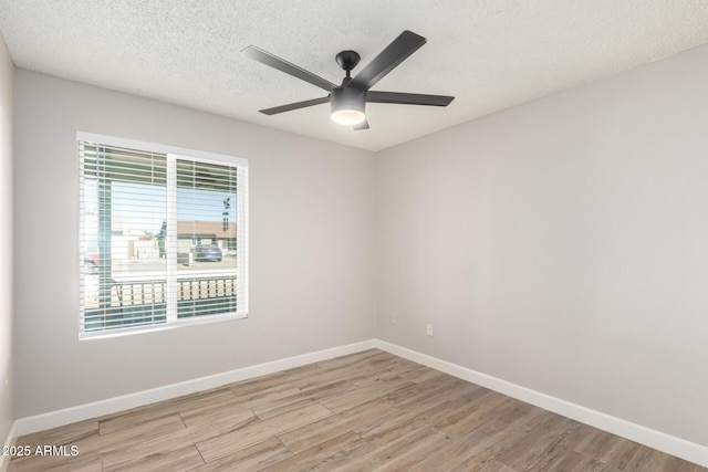 unfurnished room featuring a textured ceiling, ceiling fan, and light hardwood / wood-style flooring