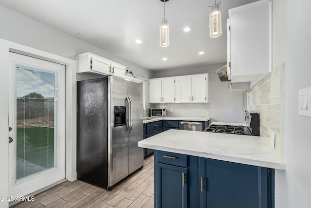 738 S Pomeroy, Mesa, AZ 85210 - kitchen featuring stainless steel appliances, blue cabinets, a peninsula, light wood-style floors, and white cabinets