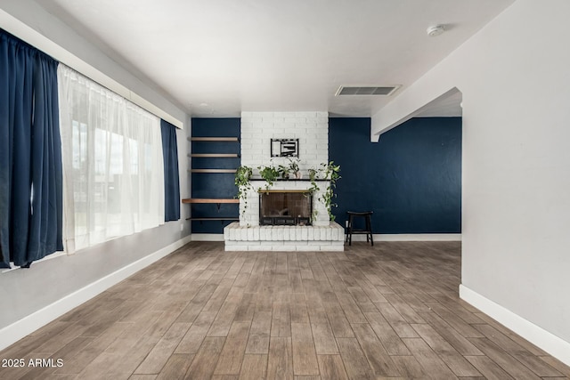 738 S Pomeroy, Mesa, AZ 85210 - unfurnished living room featuring wood finished floors, baseboards, and a fireplace